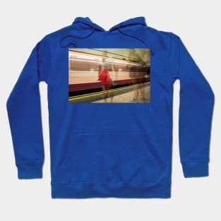 conceptual image people on underground platform as train arrives in motion blur. Hoodie